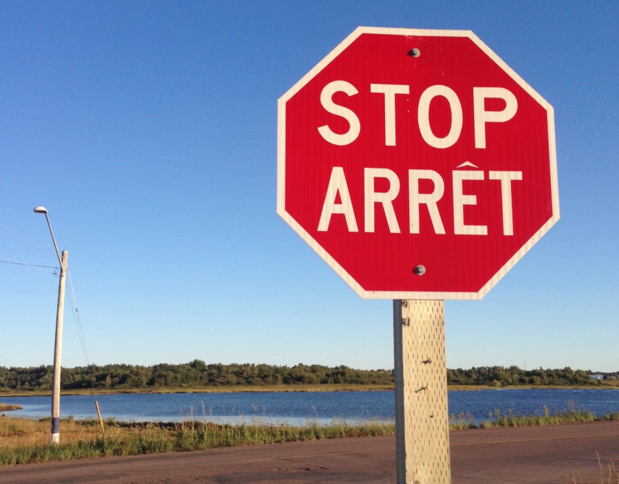 In France, stop signs read "Stop." In Quebec, they read "Arrêt.” In New Brunswick, both words appear on stop signs. In France, stop signs read "Stop." In Quebec, they read "Arrêt.” In New Brunswick, both words appear on stop signs.